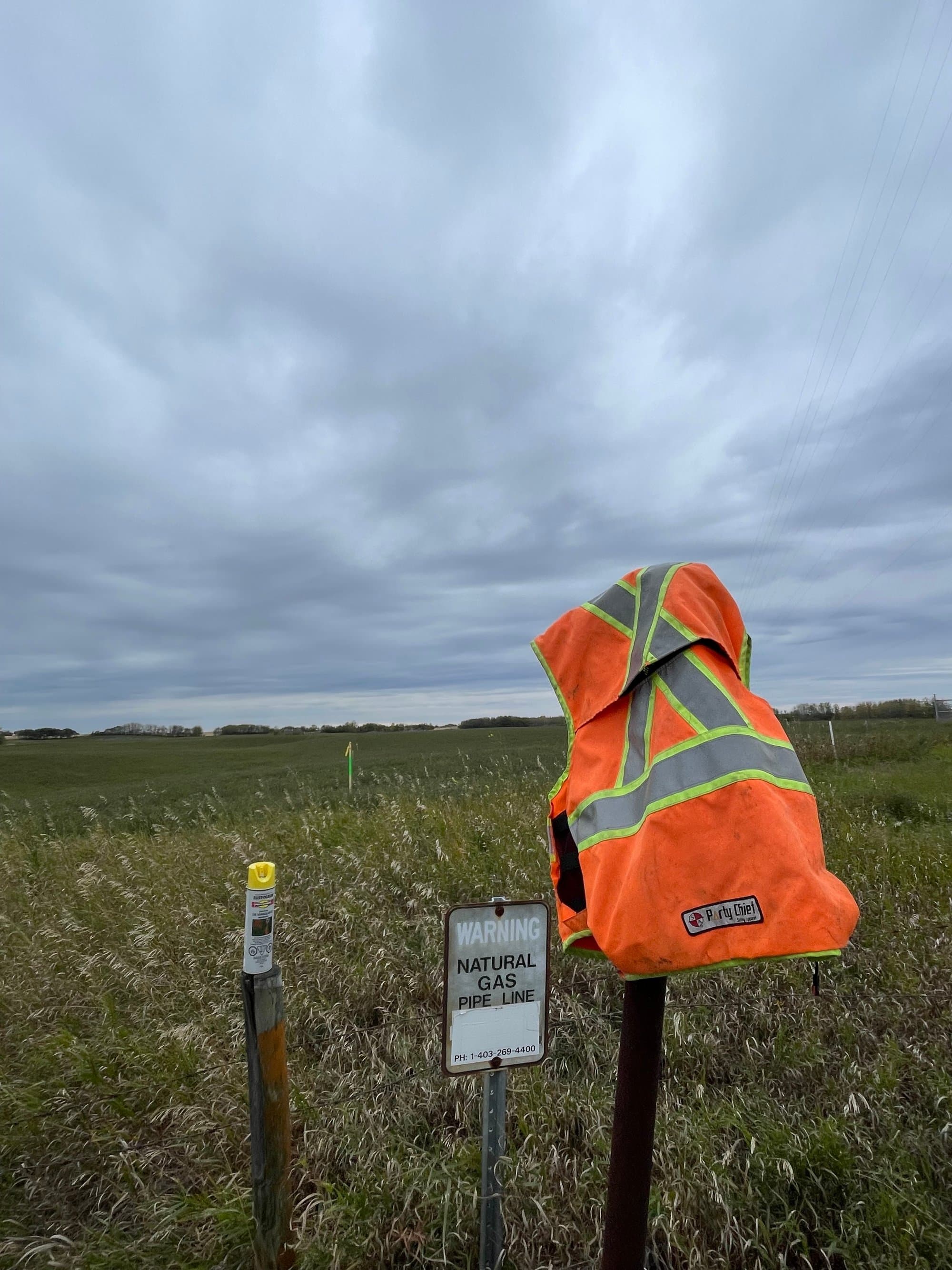 High-vis vest and warning signage before ground disturbance