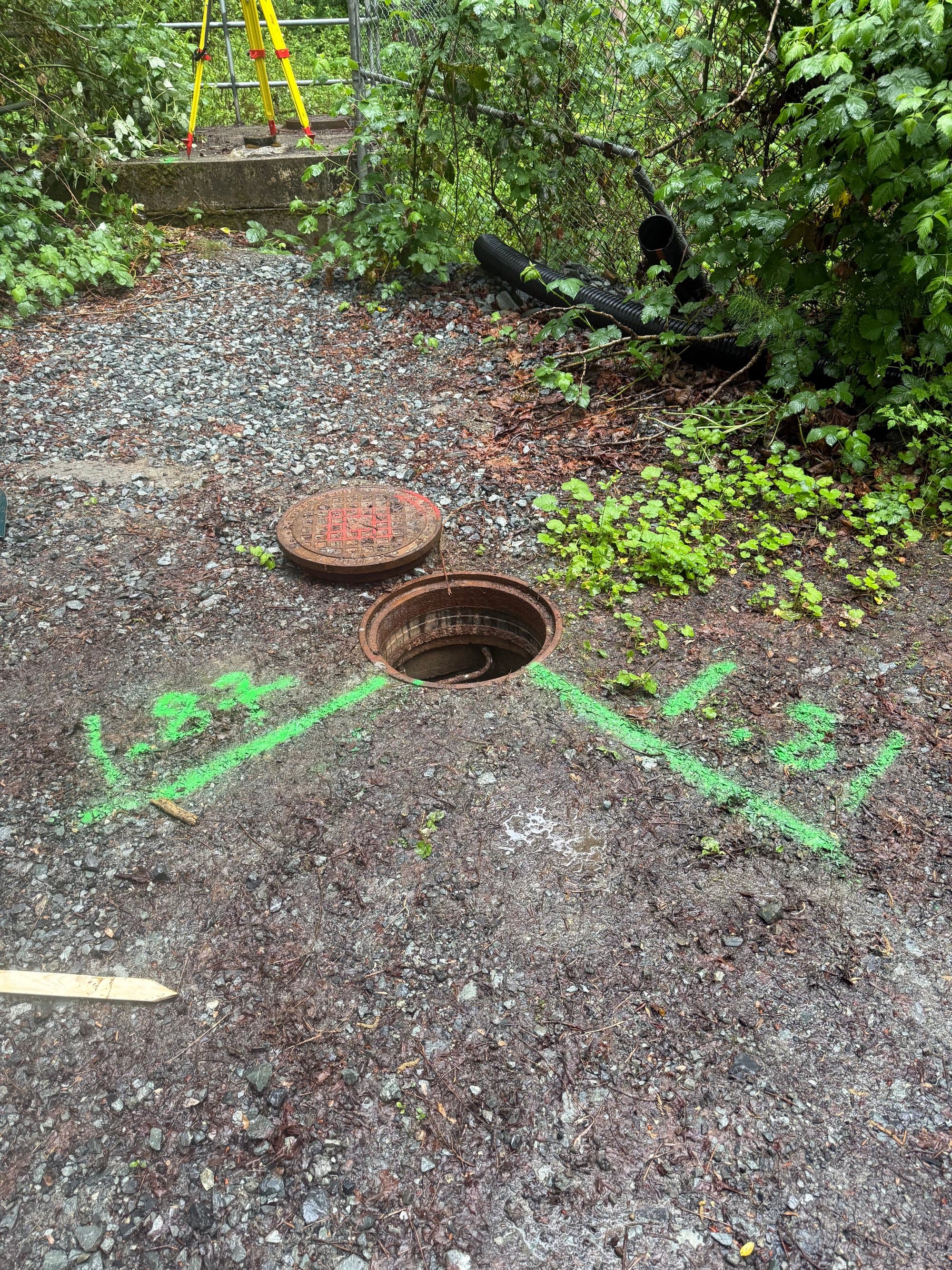 Painted invert depths beside a manhole