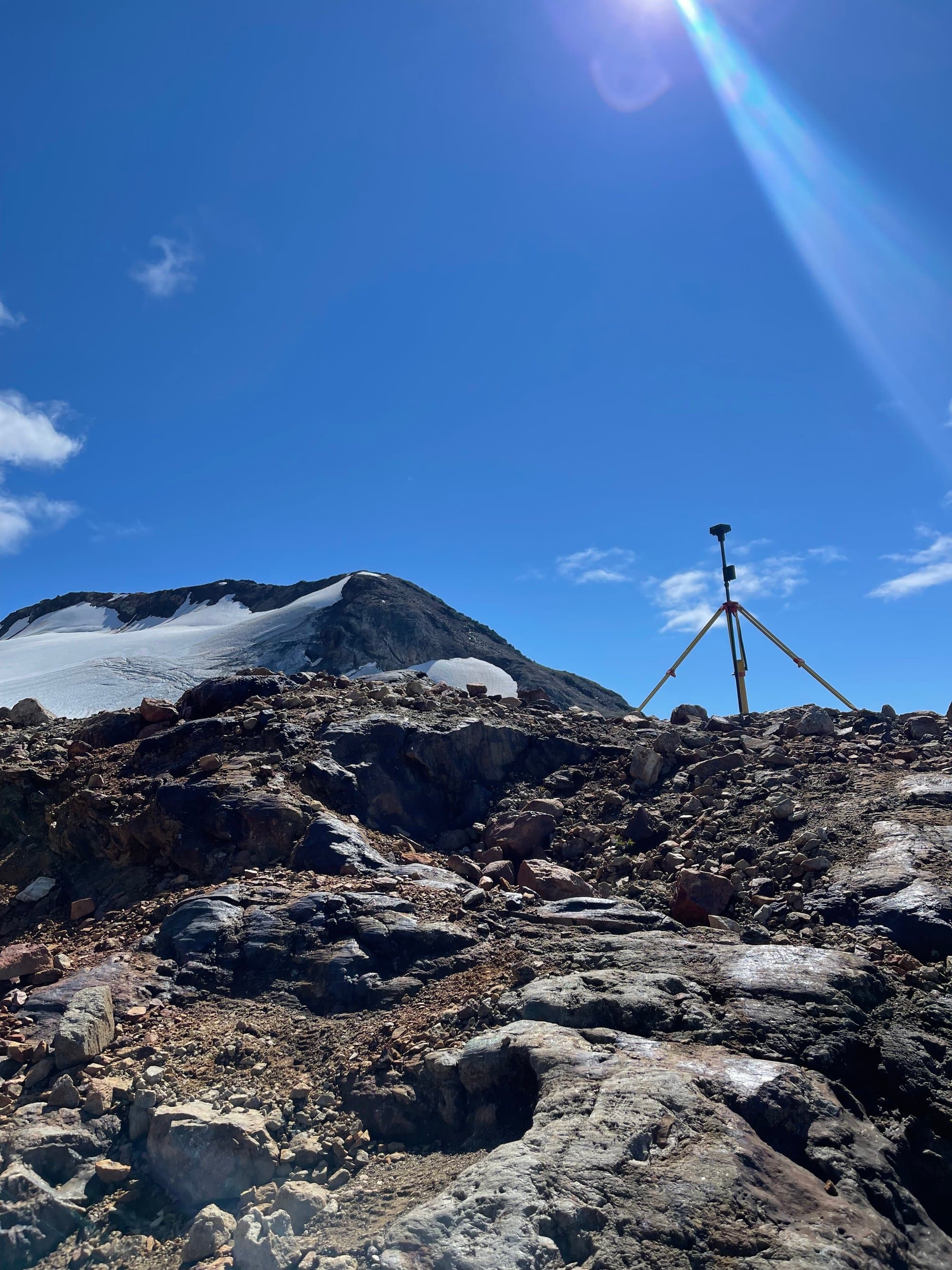 GNSS tripod on a glacier peak during a remote mining survey