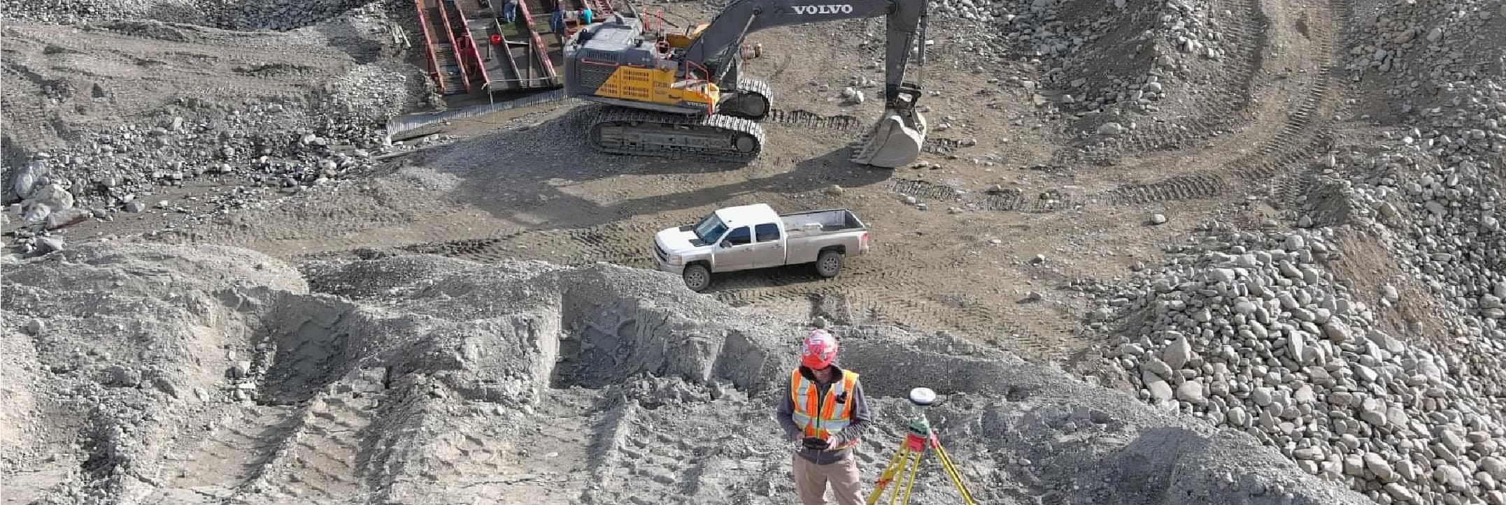 PCI surveyor on GNSS control in an active pit beside the excavator