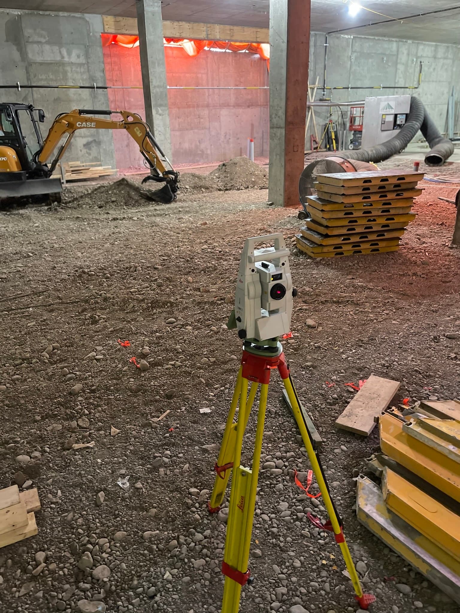 Survey instrument setup on an active construction site