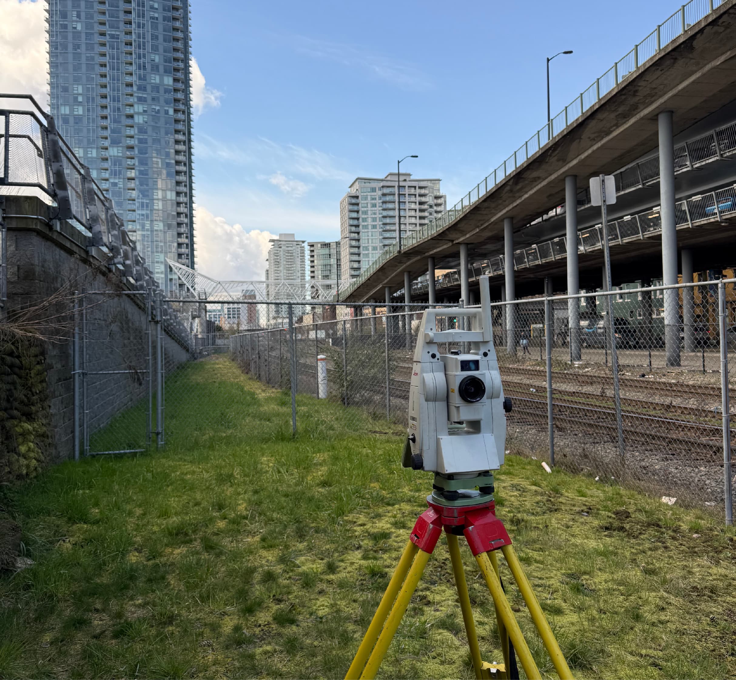 PCI Surveys robotic total station set up on an active urban construction site