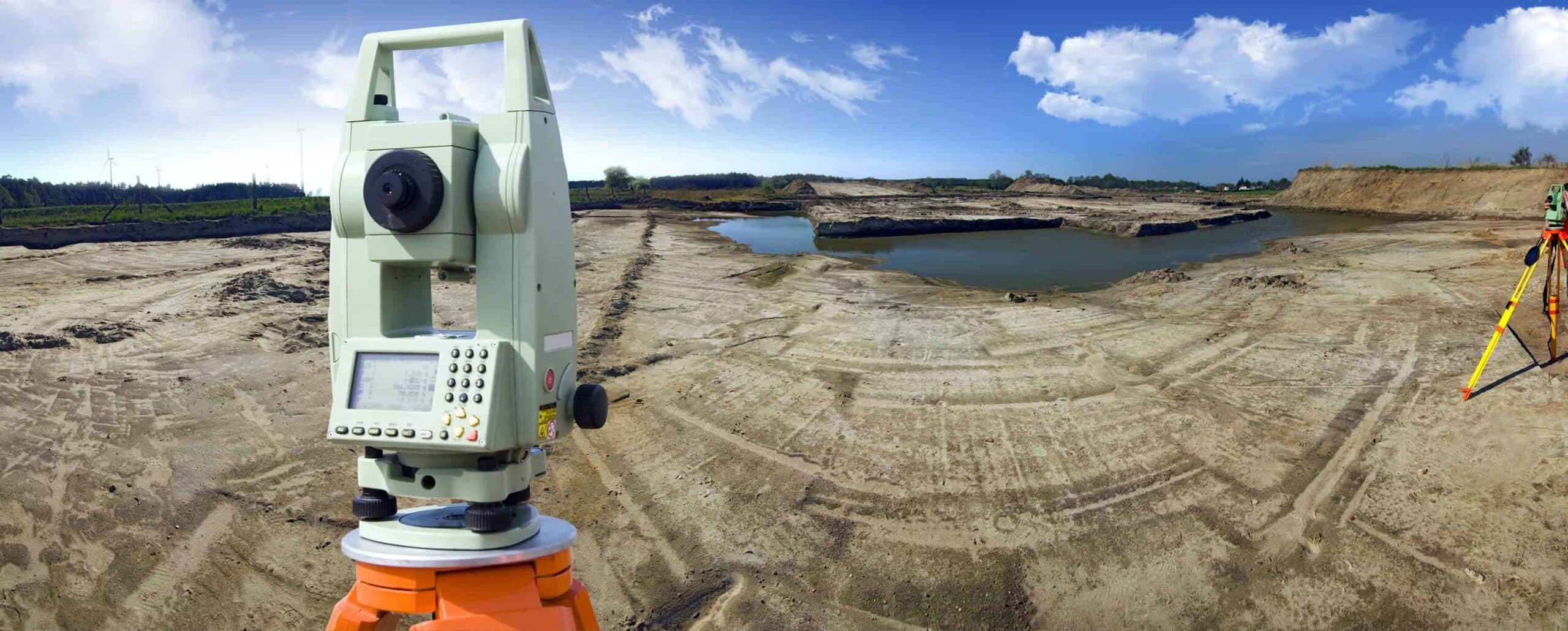 Construction surveyor running layout on an active site