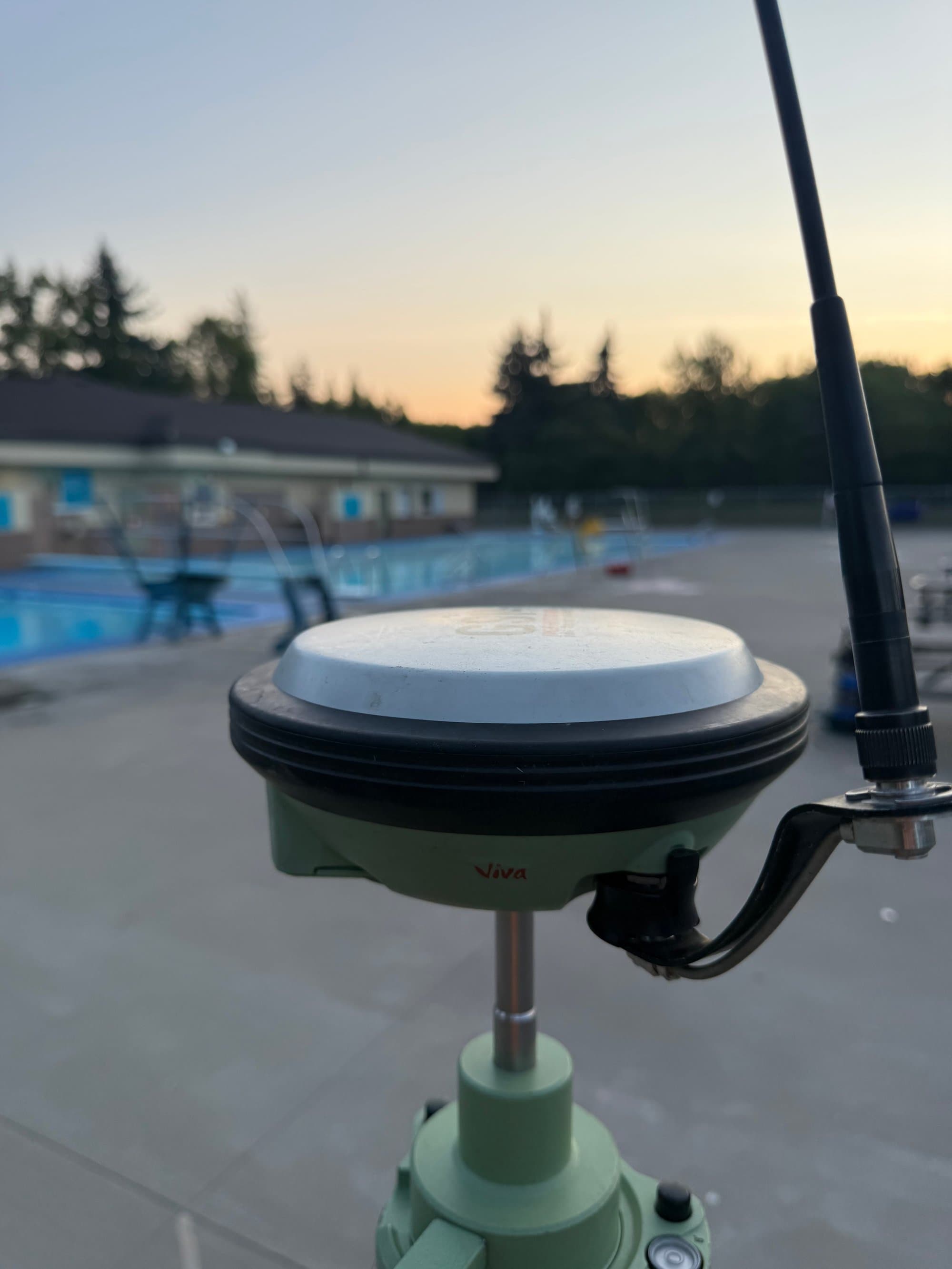 GNSS antenna silhouetted at sunset