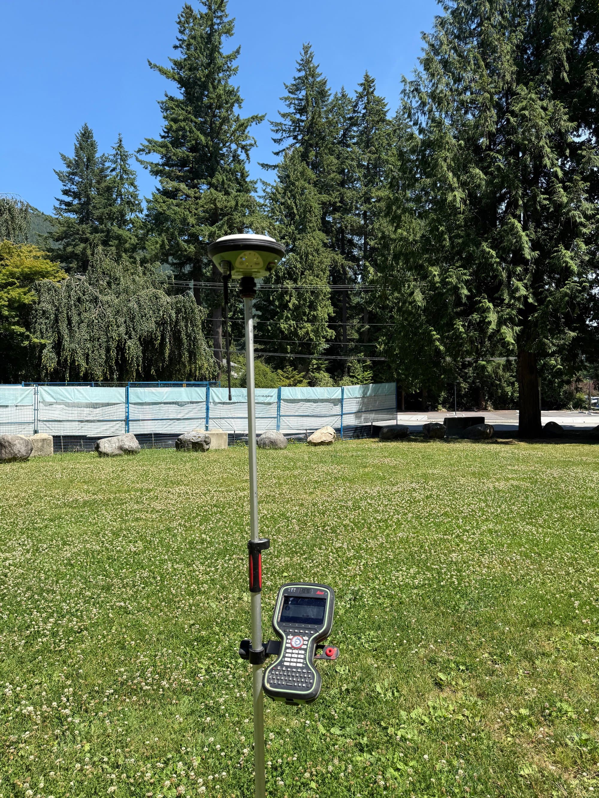 GNSS base beside a park pool fence