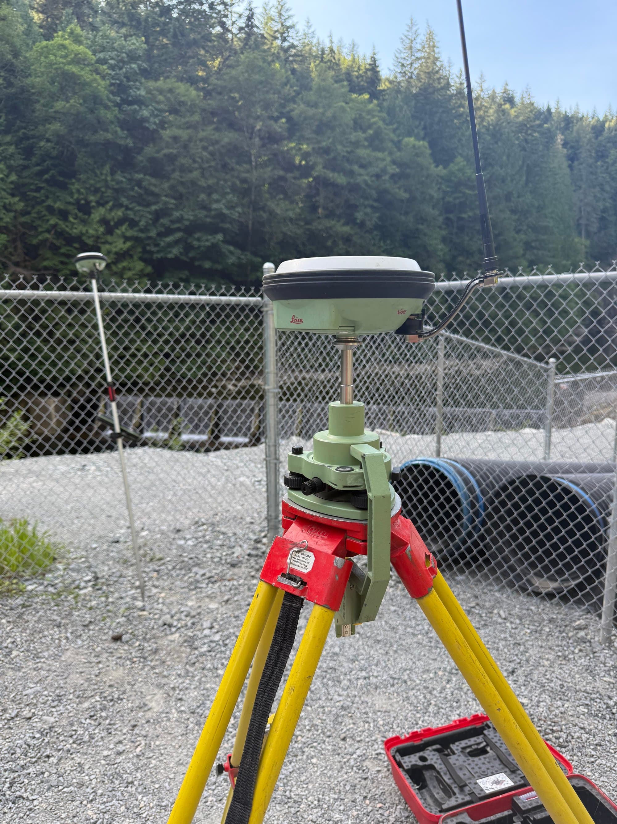 GNSS shot beside culvert stockpiles in a materials yard