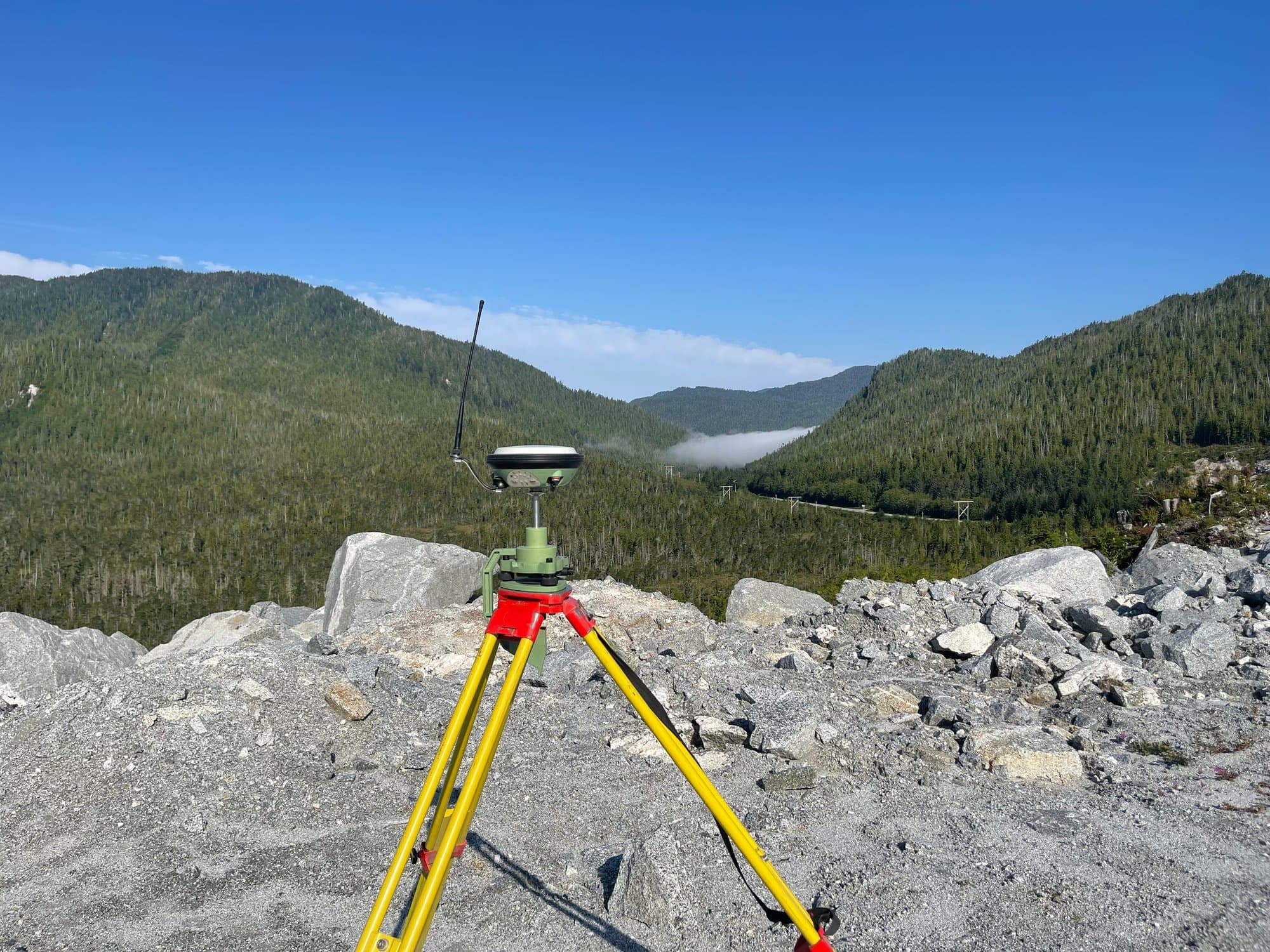 GNSS receiver on a rock outcrop overlooking a valley