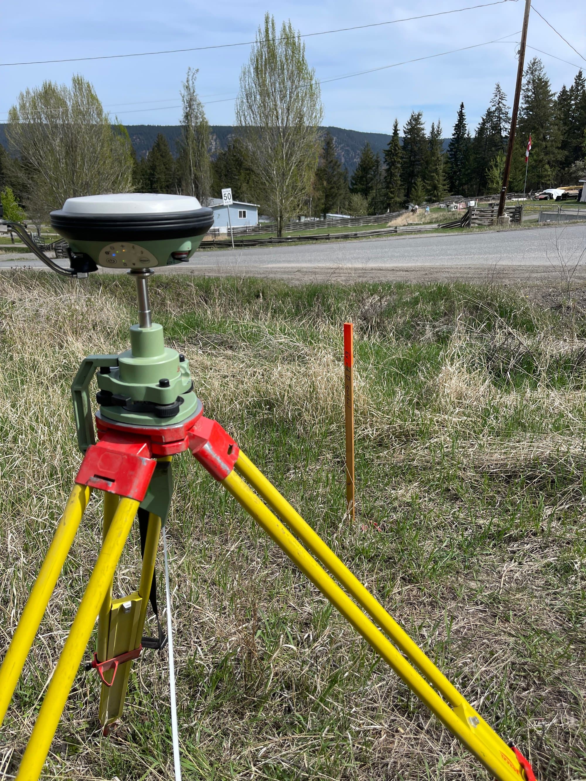 GNSS tripod in roadside grass