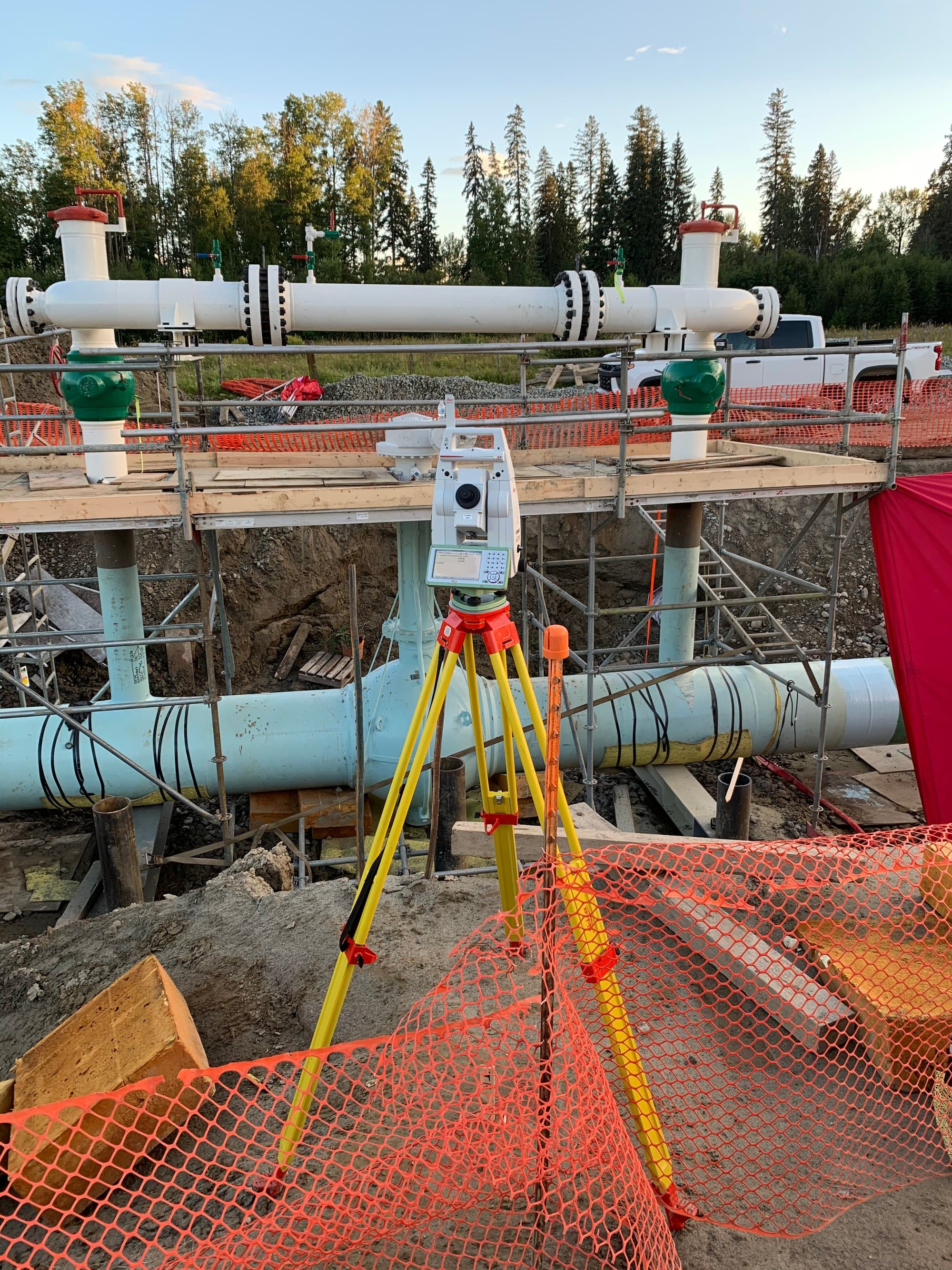 Total station guiding pipeline placement in an open trench