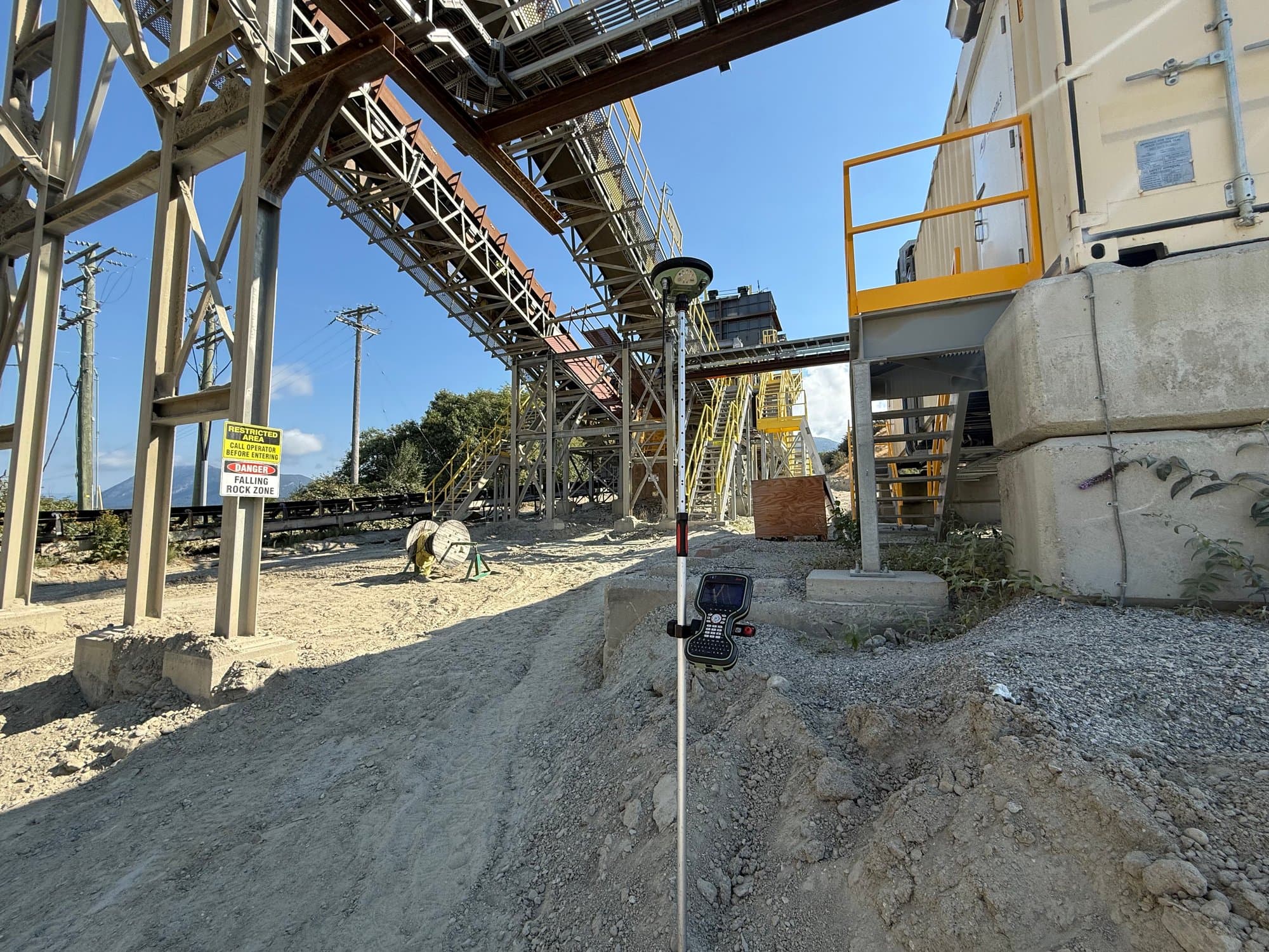 Survey control set beneath a mine conveyor structure