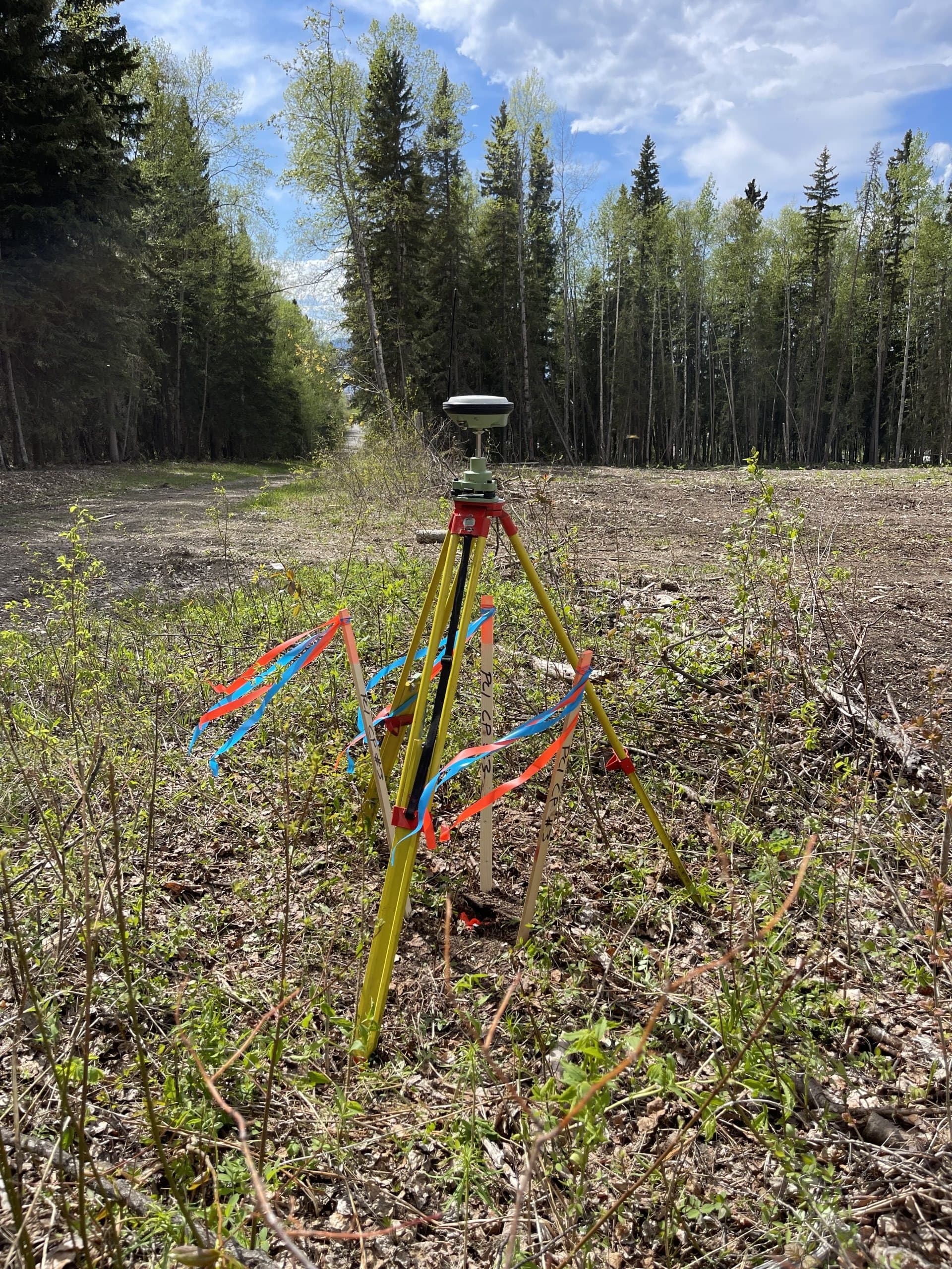 GNSS survey equipment collecting topographic data on a forested site near Prince George