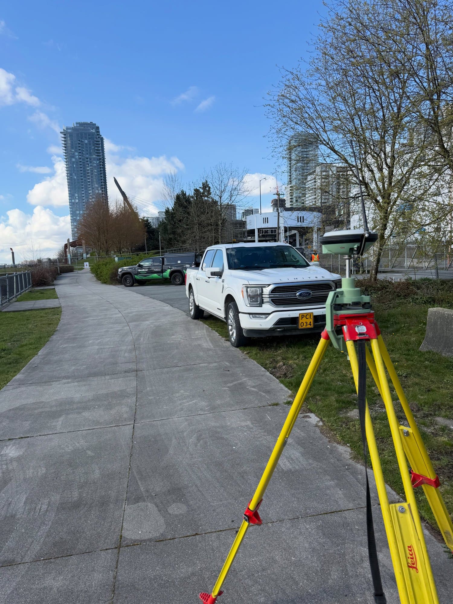 Total station on a city pathway with the trucks behind