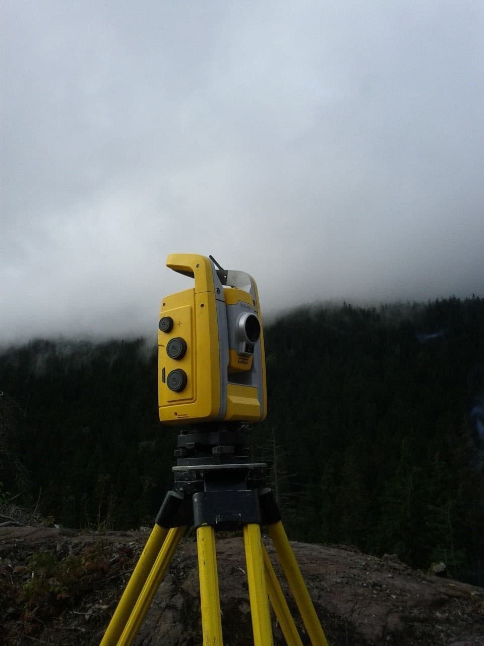 Total station working a fog-bound ridge
