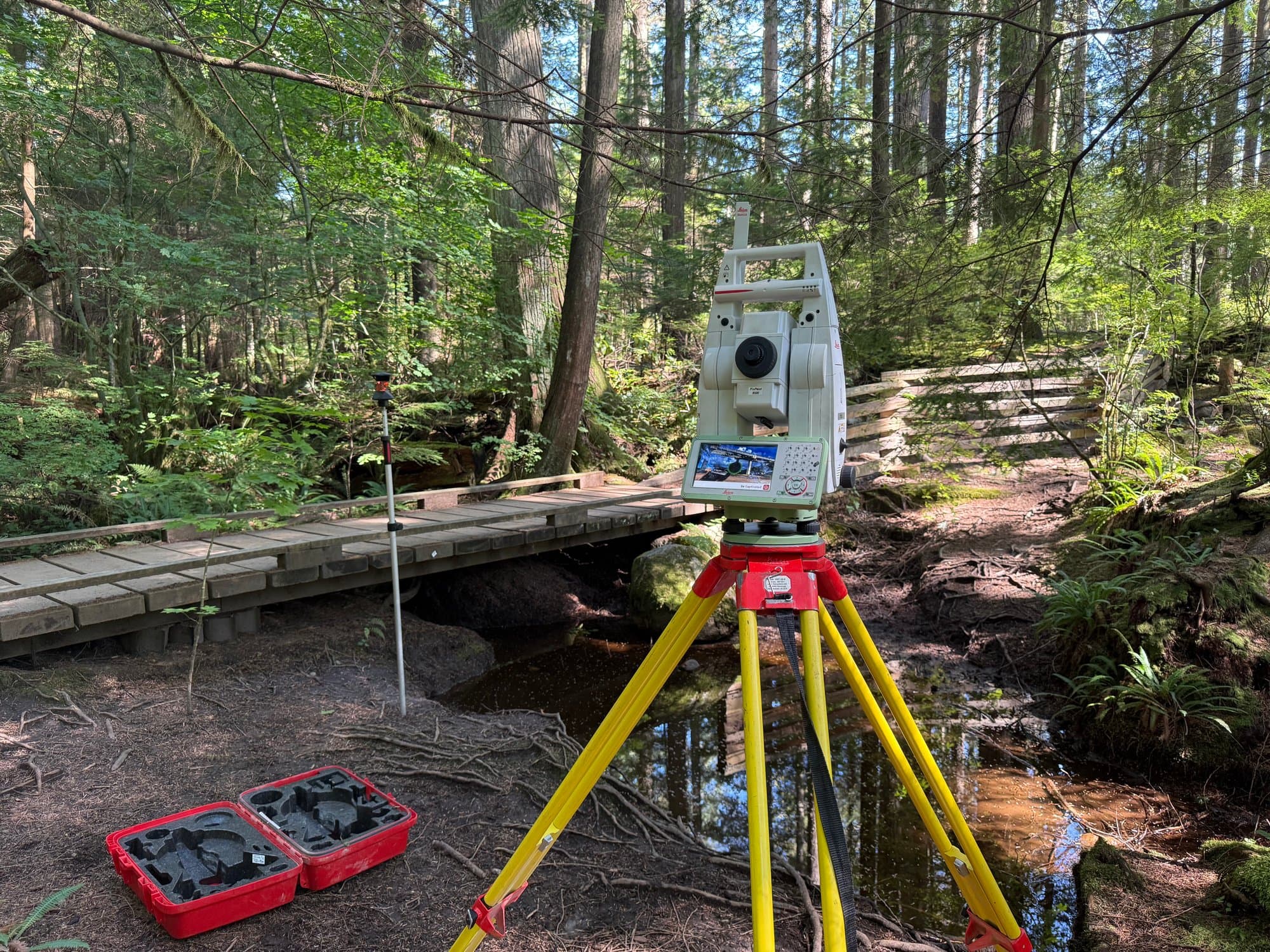 Creek bridge survey in the forest with a total station