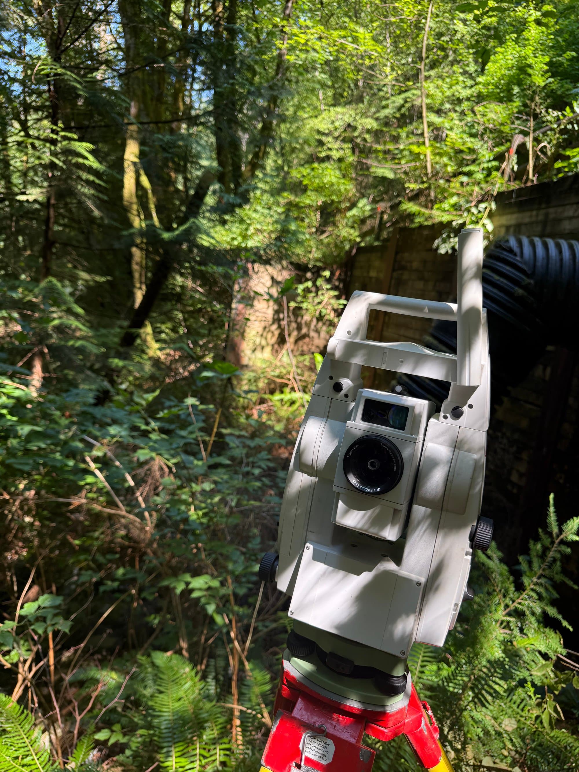 Total station in cool forest shade
