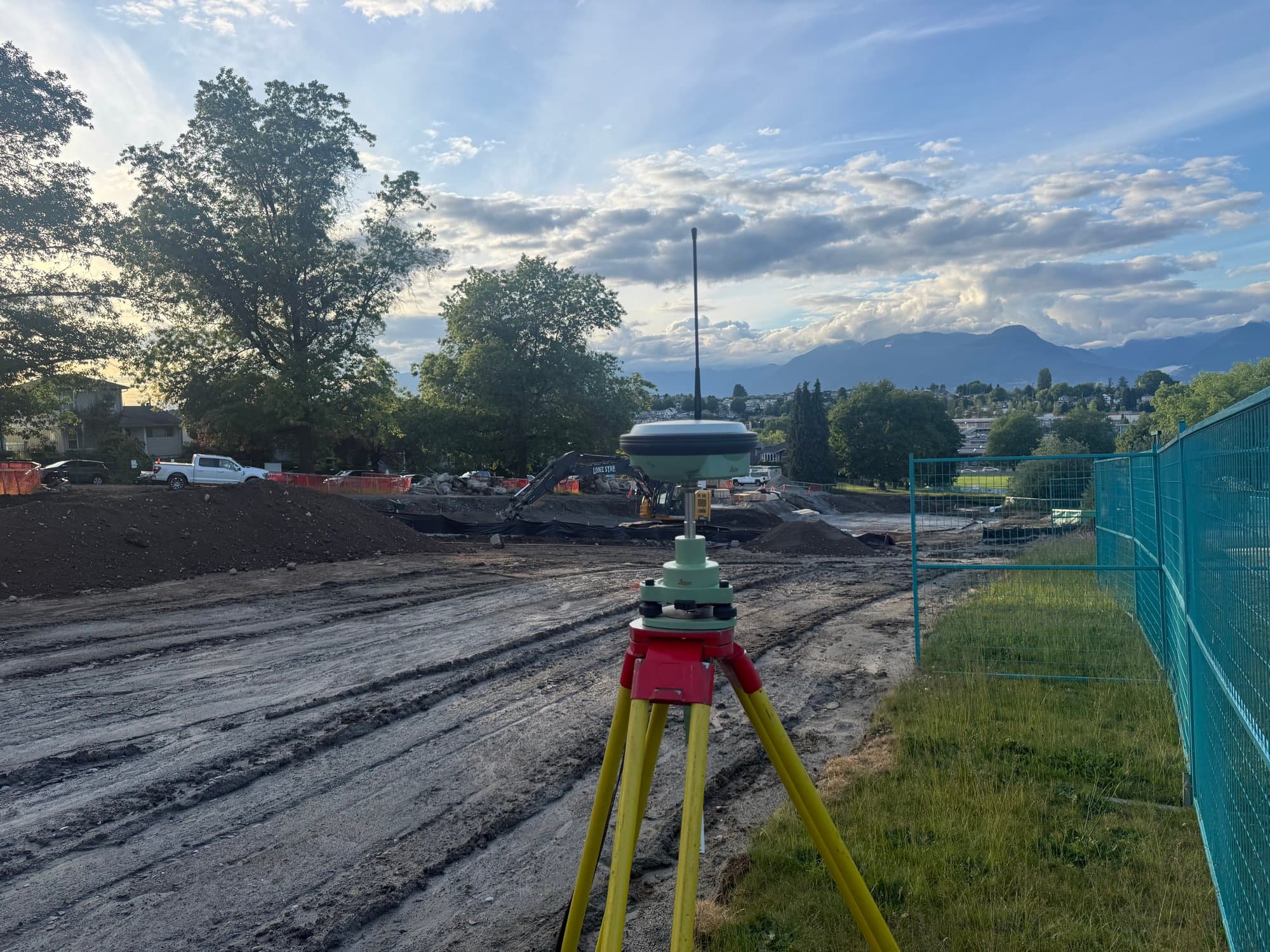 Total station on a freshly graded site at sunrise