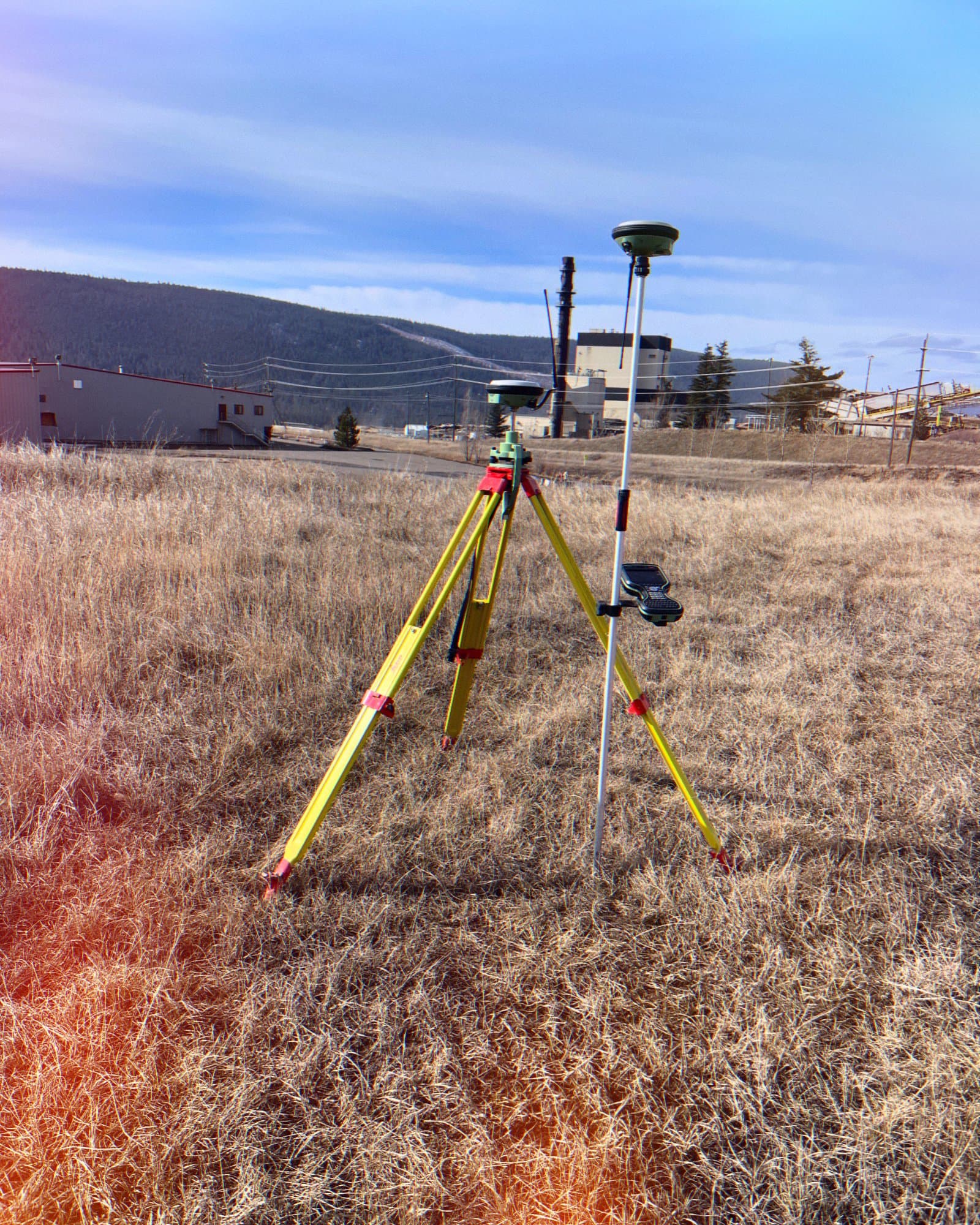 Tripod and lath in open grassland