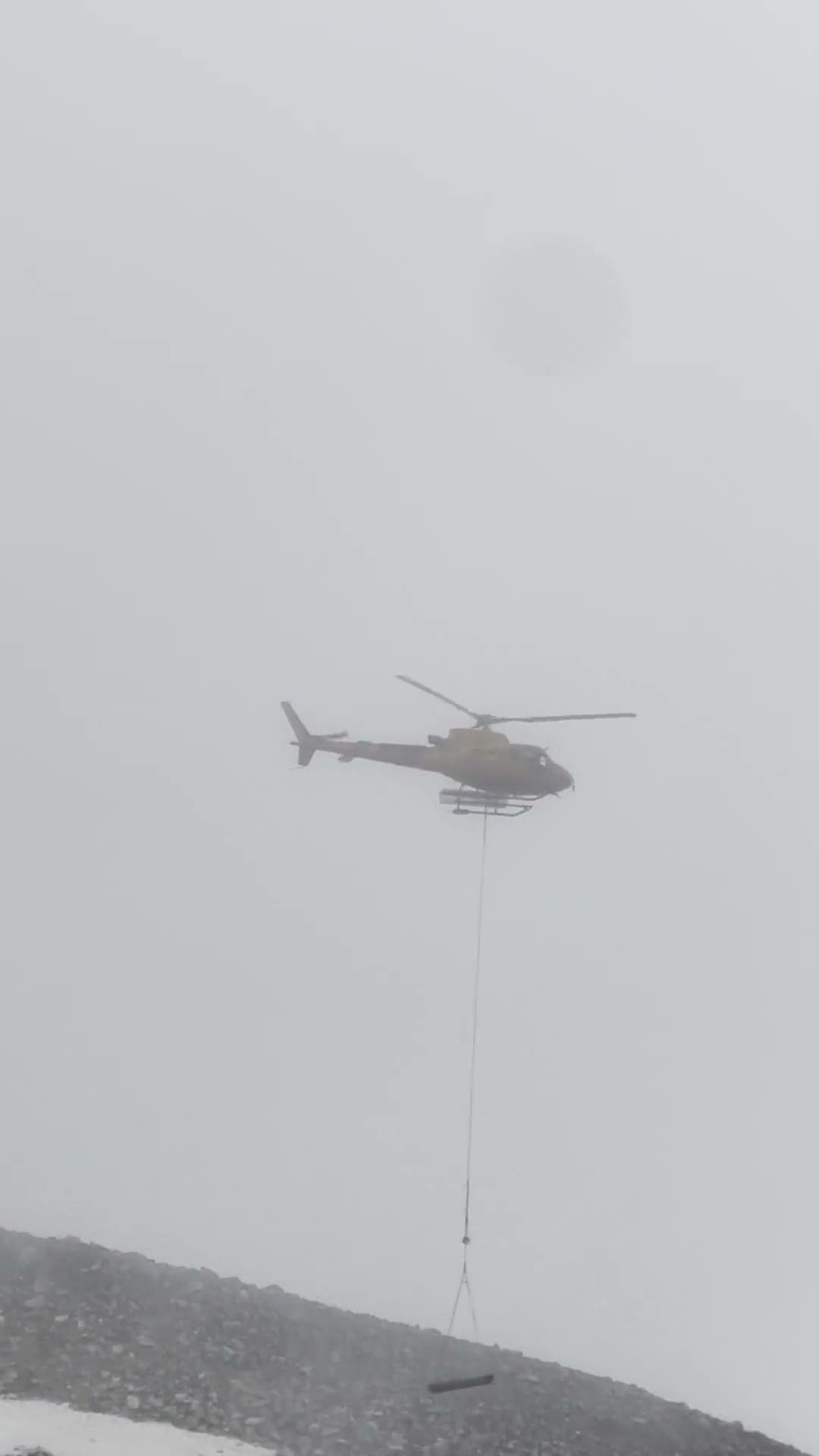 Helicopter working a remote glacier moraine survey site