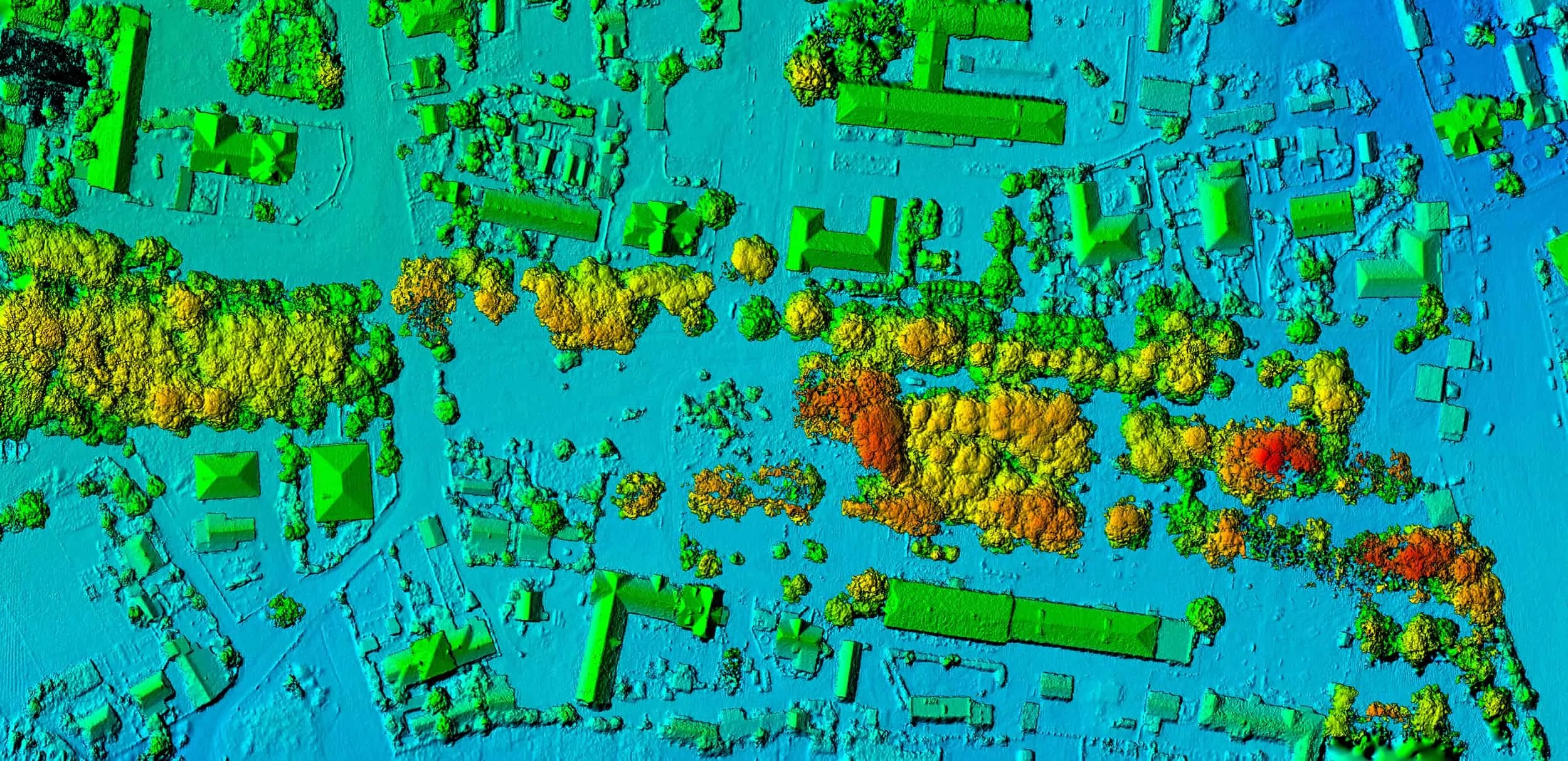 Colorized LiDAR point cloud of a townsite — buildings, trees and open ground in elevation bands