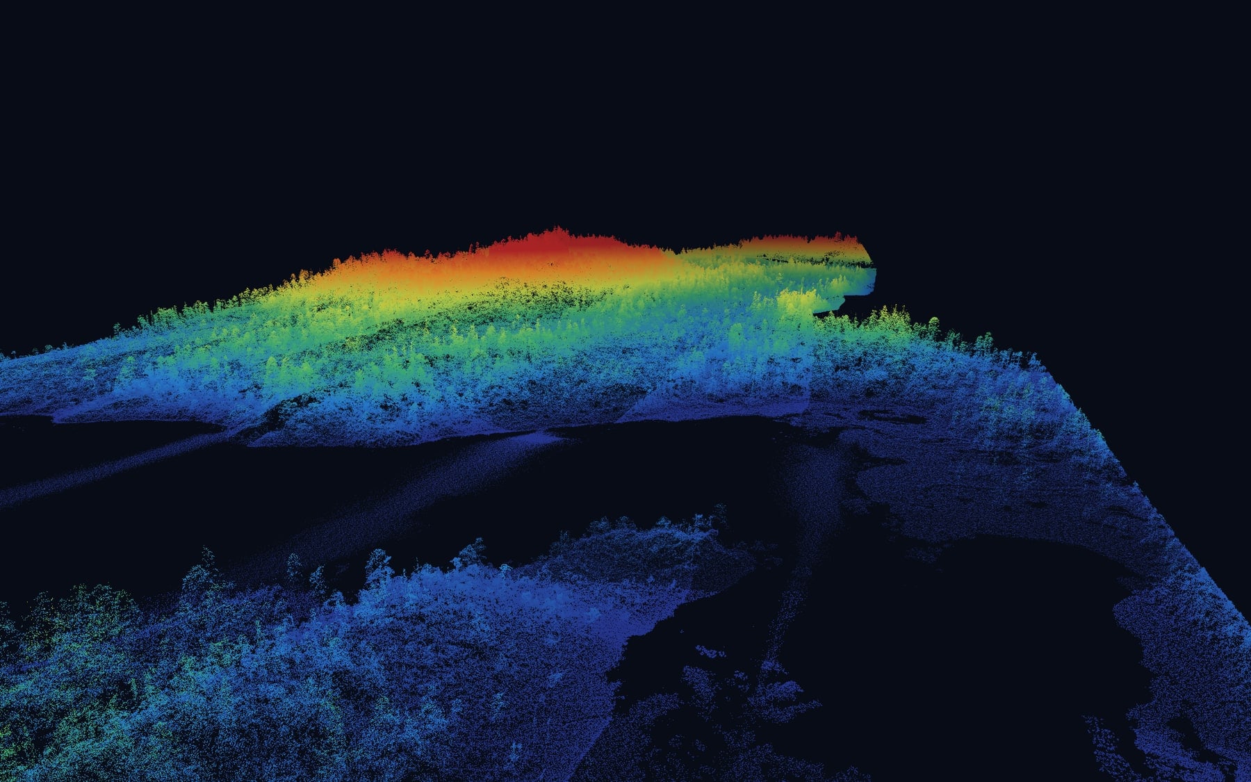 Oblique view of a drone LiDAR point cloud over forest and a lake in northern BC, coloured by elevation from blue lakeshore to red hilltop