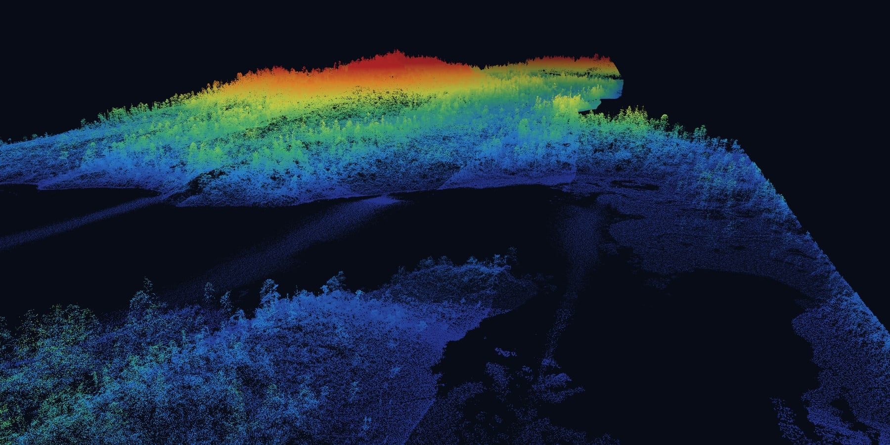 Drone LiDAR point cloud of a forested hill above a lake, every tree captured, coloured blue to red by elevation