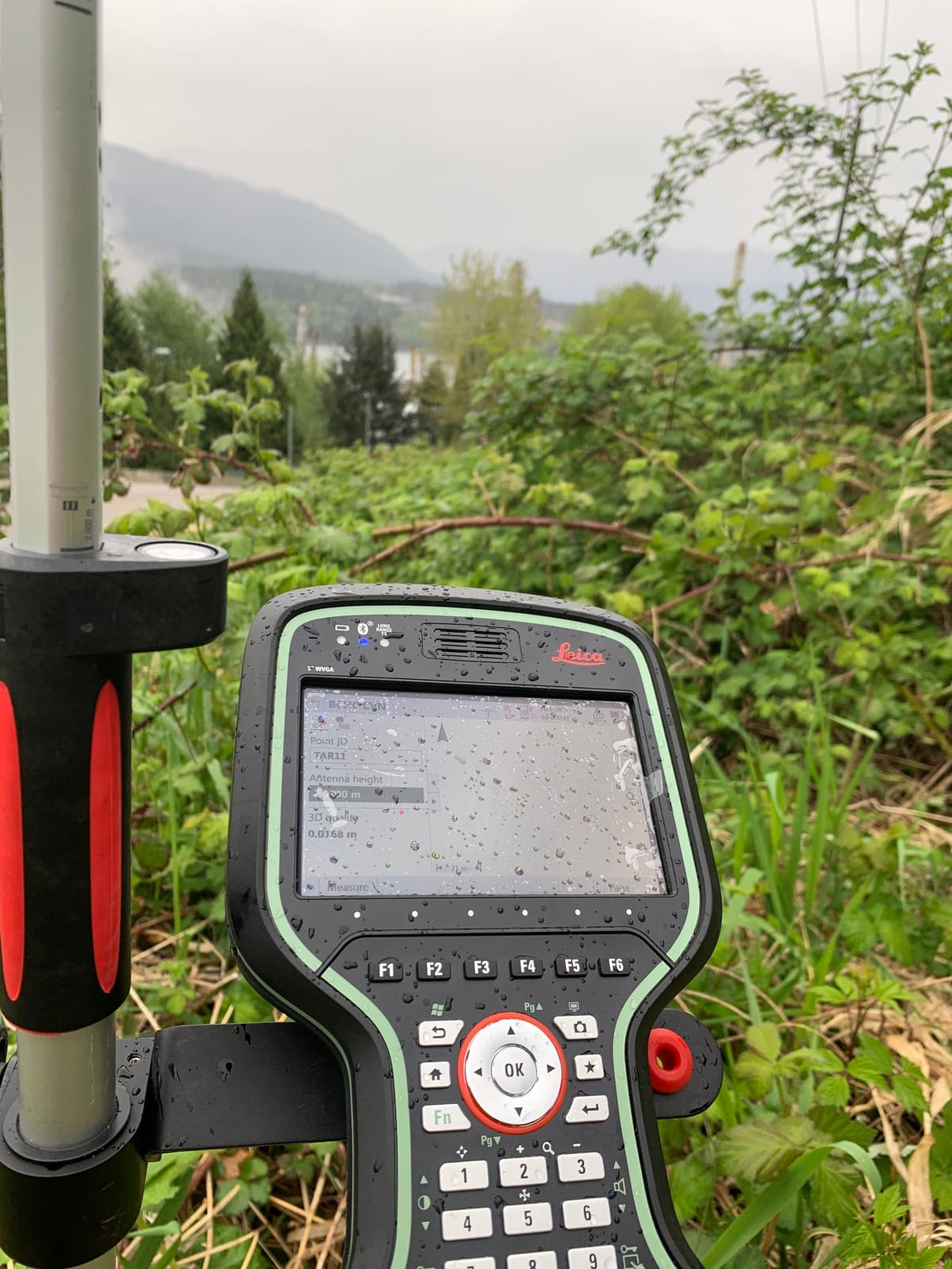 Survey field controller streaked with rain during layout in wet conditions