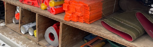 PCI's surveying tools and equipment stored in a truck bed, including wooden stakes, marking flags, traffic cones, hammer, level, and other field essentials.