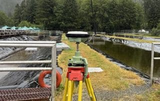 Commercial construction surveyor featured image showing GNSS setup on a commercial project in BC.