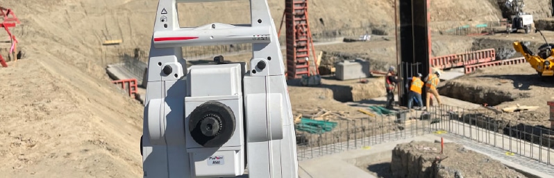 Survey equipment on a commercial construction site in Vancouver for layout and grade verification.
