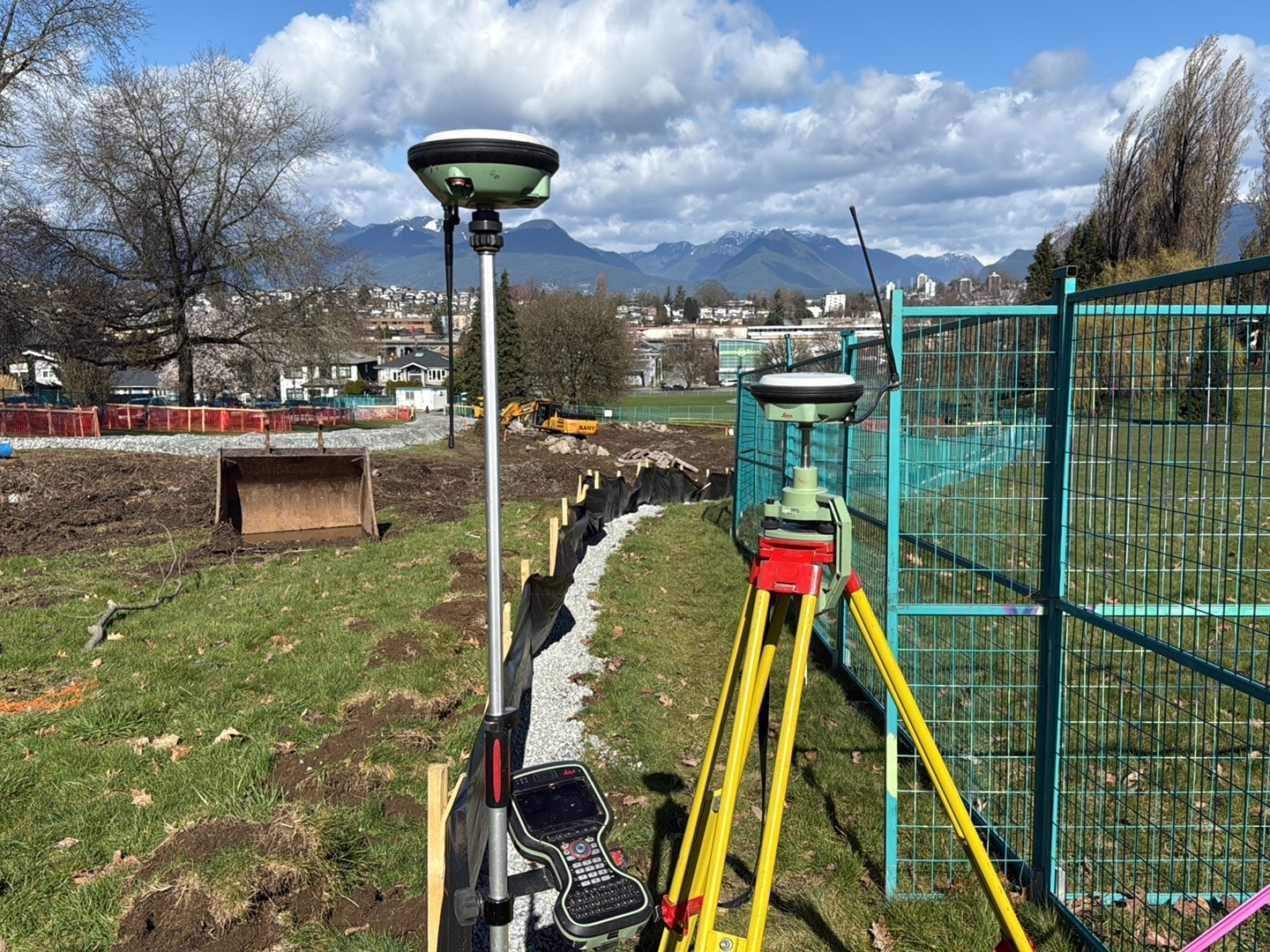 Construction surveying equipment set up on an active construction site for layout and site control in BC and Alberta.