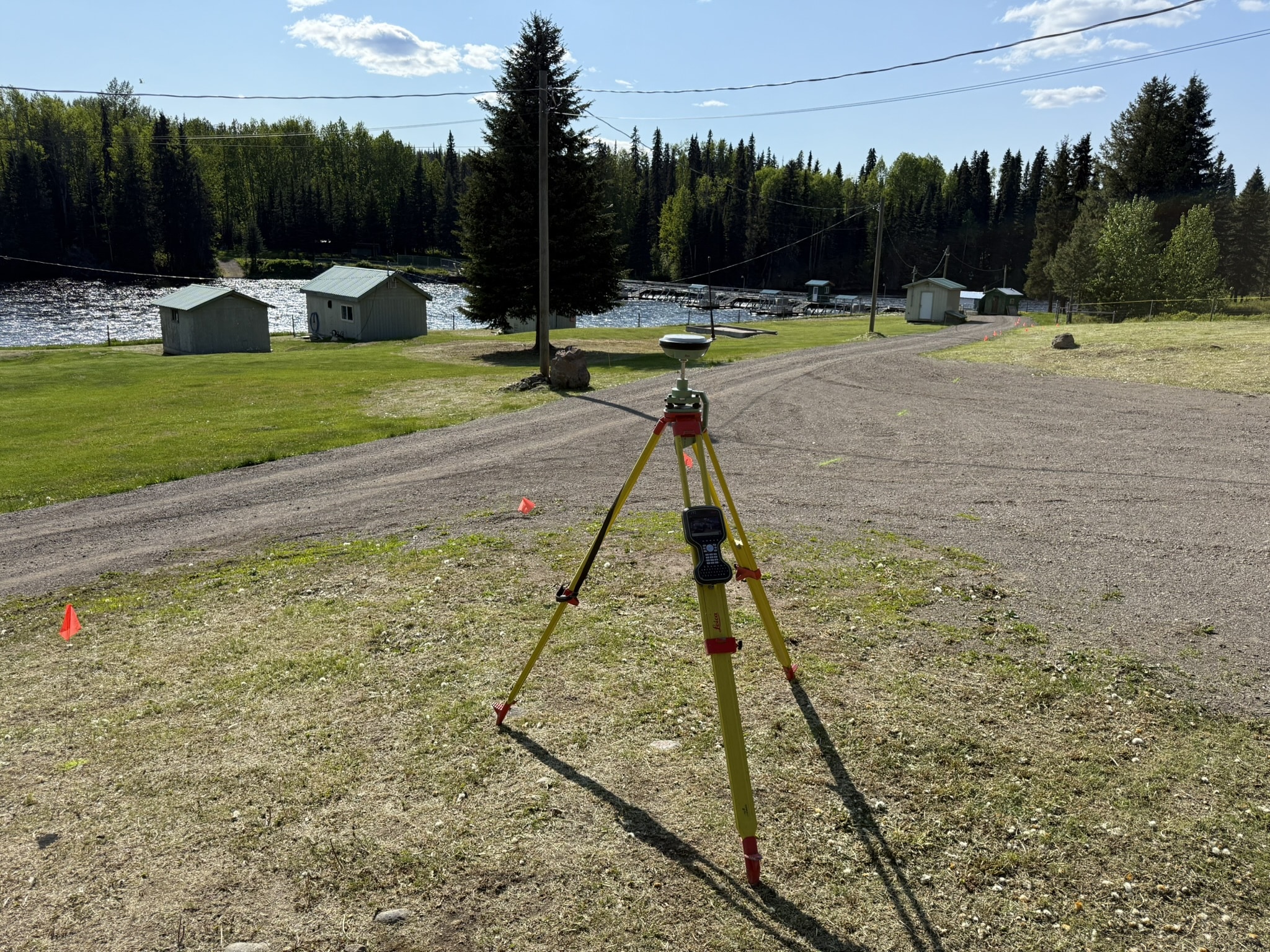 Topographic survey equipment set up on a construction site for grading, drainage, and site planning in BC and Alberta.